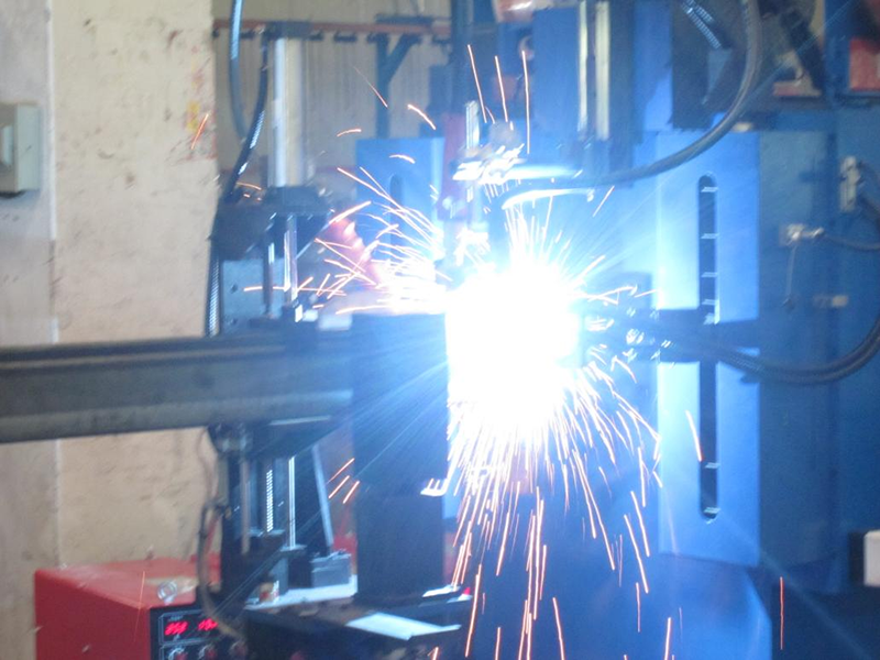 Industrial robotic welding arm fabricating the structural frame of the automated shuttle